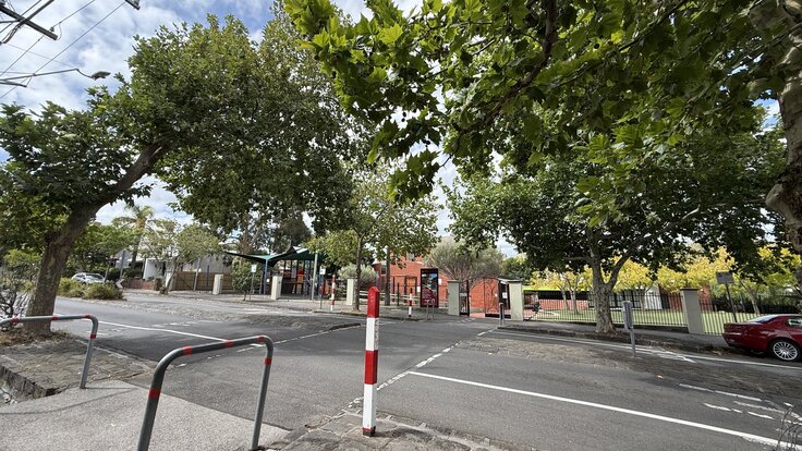 Wellington Street at the Clifton Hill Primary school gate, showing the existing crossing with an ineffective speed hump and no zebra marking